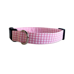 Add a touch of charm with the Duke & Fox® Pink Gingham Dog Collar. Handmade in Tennessee, this sweet pink checkered collar is perfect for any stylish pup. Personalize it with custom embroidery to feature your dog’s name for a one-of-a-kind look. Crafted with durable materials and quality hardware, it’s designed for comfort and everyday wear.