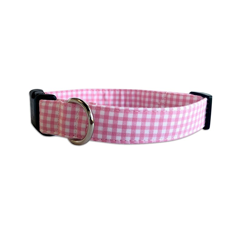 Add a touch of charm with the Duke & Fox® Pink Gingham Dog Collar. Handmade in Tennessee, this sweet pink checkered collar is perfect for any stylish pup. Personalize it with custom embroidery to feature your dog’s name for a one-of-a-kind look. Crafted with durable materials and quality hardware, it’s designed for comfort and everyday wear.