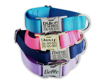 May include: A stack of personalized dog collars in blue, pink, navy, and lavender. Each collar has a silver buckle engraved with a name and contact information. The collars are made of durable nylon material.