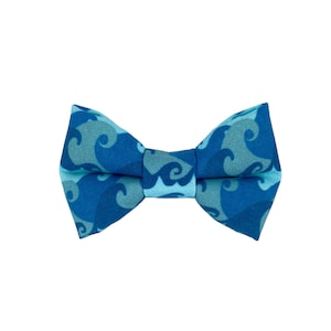 May include: A blue bow tie with a wave pattern.