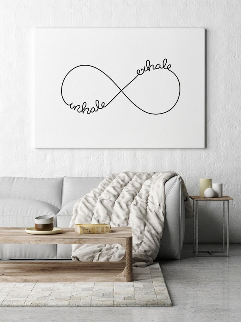 May include: A black and white infinity symbol with the words "inhale" and "exhale" written on it. The symbol is on a white background.