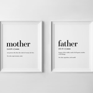 May include: Two black and white framed prints with the definitions of the words "mother" and "father". The definition of "mother" is "one person who does the work of twenty, for free." The definition of "father" is "keeper of the wallet; coach of all sports; teacher of all things."