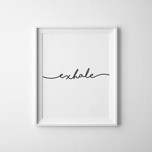 May include: A framed print with the word "exhale" in a delicate, cursive font. The text is black against a white background, encased in a white frame. The minimalist design creates a sense of calm and is suitable for home decor.