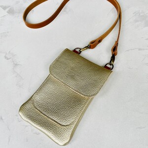 Champagne gold metallic leather smartphone bag with a crossbody strap