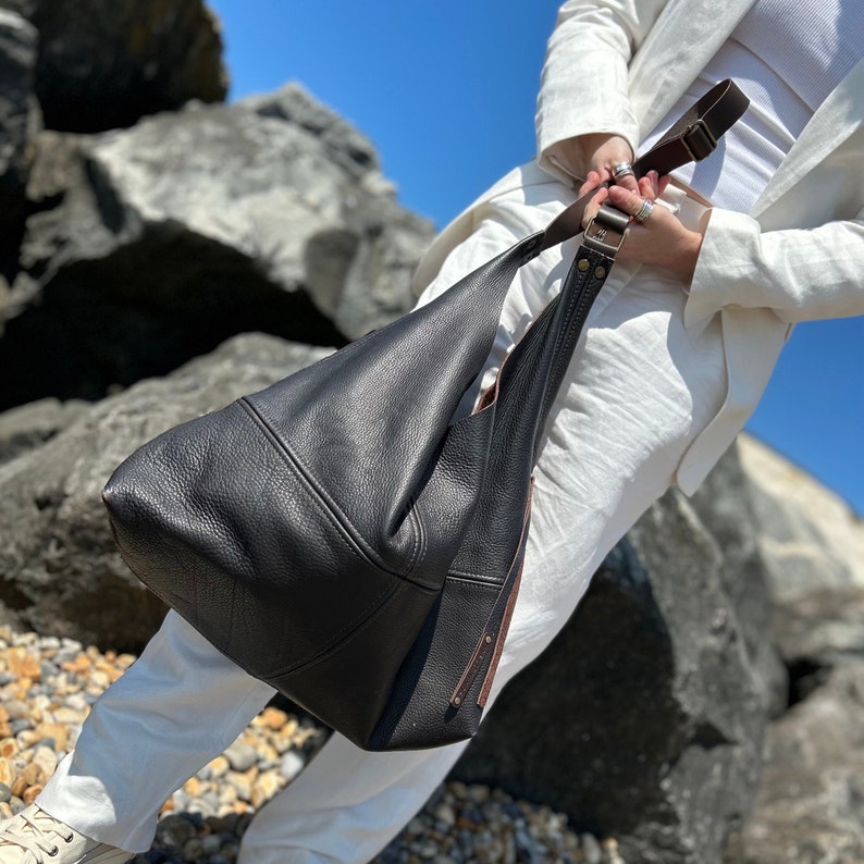 Large dark brown leather hobo bag with a cross body strap