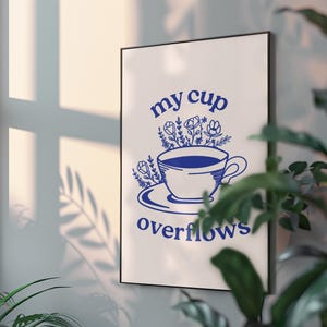May include: A white poster with blue text and a blue illustration of a cup overflowing with flowers. The text reads "my cup overflows".