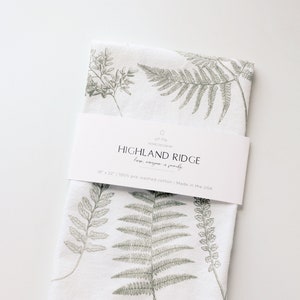 Fern Fronds Tea Towel for the kitchen. A white flour sack tea towel is covered by a variety of large sage green fern fronds