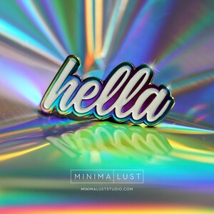May include: A pin with the word "hella" in white cursive lettering, outlined in iridescent colors. The pin is set against a holographic background with the text "MINIMA LUST" and "minimaluststudio.com" at the bottom.