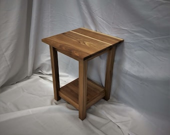 May include: A wooden end table with a single shelf. The table is made of light and dark wood, creating a striped pattern on the top surface.