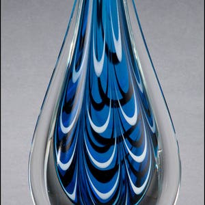 A blue glass award with white and black swirling designs on a clear glass base. The base has a black plaque with silver lettering that reads 'US Foods, Top Sales, Mark Deminna, January 2016.'