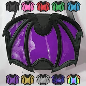 May include: A purple and black bat wing-shaped bag with a shiny, glossy finish. The bag has a large, open top and a zipper closure. The bag is decorated with black stitching and a black trim.