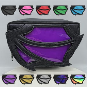 May include: A black faux leather purse with a purple iridescent window and a bat wing design. The purse has a zipper closure and a detachable strap.