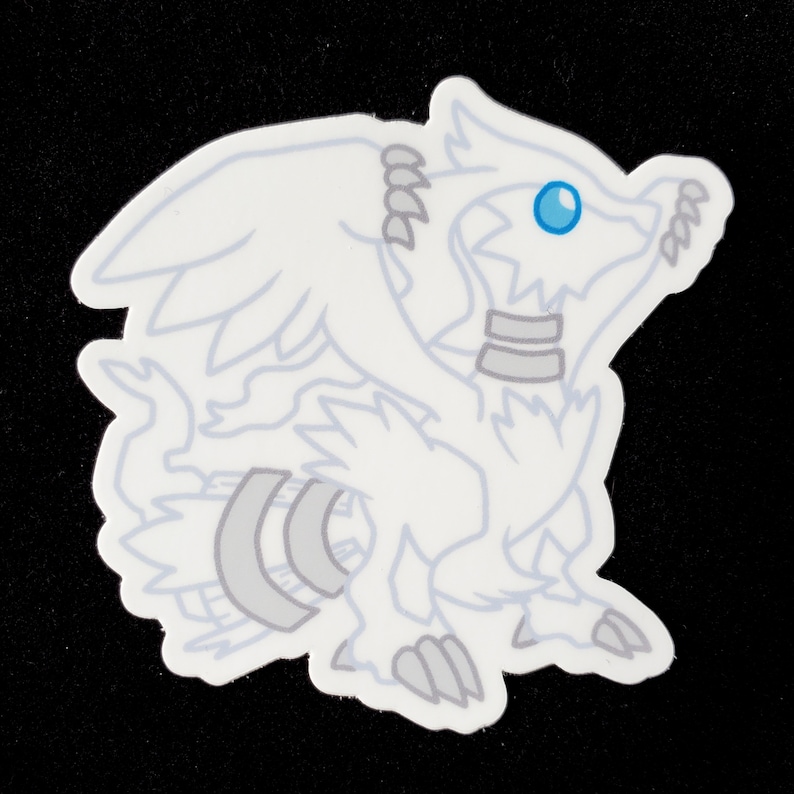 May include: White sticker of a cartoon dragon with a blue eye. The dragon has wings and a tail.
