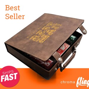 May include: A brown leatherette case with a personalized inscription "MICHAEL WALLBERG BEST" in gold lettering. The case is open to reveal a set of playing cards and poker chips.