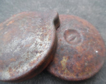 Two rusty gas caps