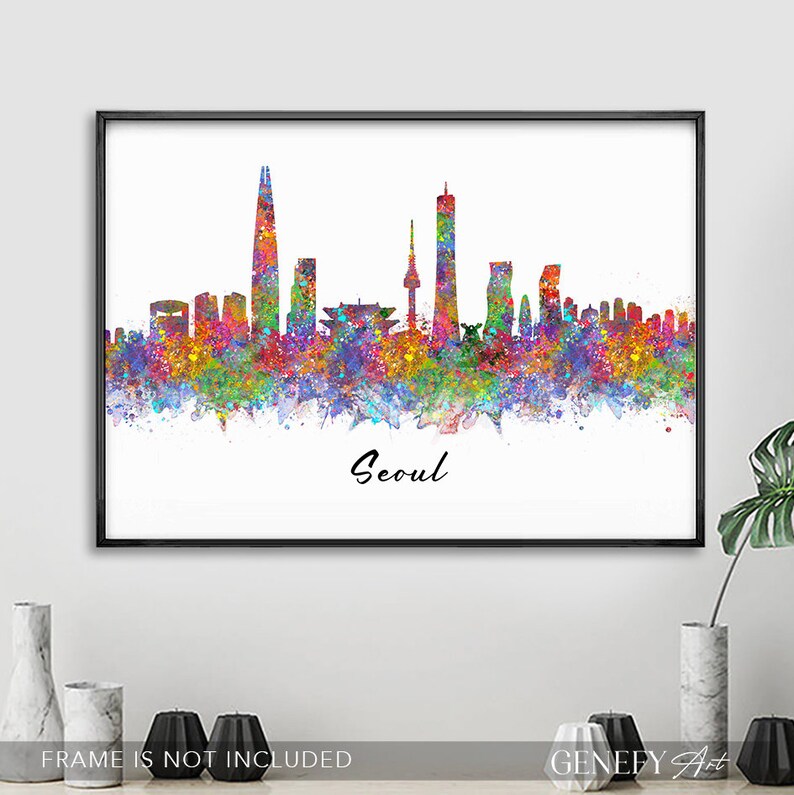 May include: A colorful watercolor painting of the Seoul skyline. The painting features the iconic Lotte World Tower, N Seoul Tower, and other skyscrapers. The city is depicted in a vibrant rainbow of colors, with splashes of paint creating a dynamic and artistic effect. The word "Seoul" is written in black script at the bottom of the painting.