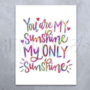 May include: A white print with the words "You are MY Sunshine, MY ONLY Sunshine" in colorful, watercolor-style lettering. Small red hearts accent the text. The print has a watercolor effect with a variety of colors.