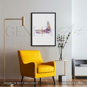 May include: A watercolor painting of an elbow joint, with the bones and tendons depicted in a colorful, abstract style. The painting is framed in a black frame and is hanging on a white wall.