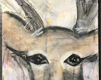 May include: A mixed media painting of a deer's head with large antlers. The deer's face is painted in shades of gray and white, with black eyes and a black nose. The background is a collage of textured paper and paint in shades of brown, gray, and white.