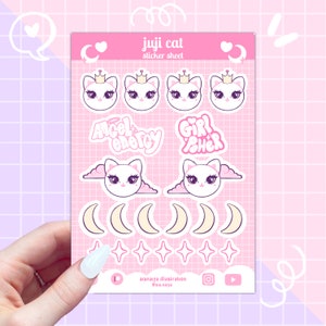 Puede incluir: Una hoja de pegatinas rosa con diseños de gatos con coronas, alas de ángel y lunas crecientes. Incluye las frases "Angel Energy" y "Girl Power". La hoja se titula "juji cat sticker sheet".