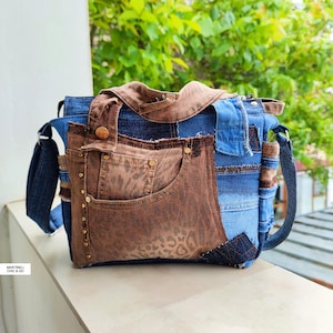 May include: A patchwork shoulder bag constructed from blue denim and brown fabric with a leopard print pattern. The bag features multiple pockets, metal rivets, a top handle, and a shoulder strap. The text MARTINELI CHIC & GO is visible.