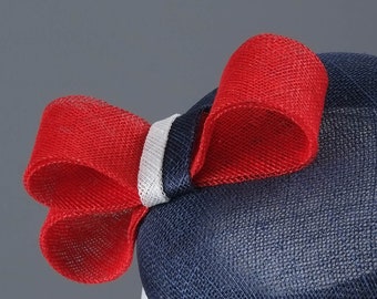Navy blue fascinator with a red bow