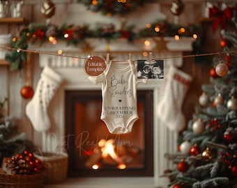 May include: A white babygrow with the text "Baby Sanders Unwrapping December 2024" and a small heart. The babygrow is hanging on a clothesline in front of a fireplace and a Christmas tree.