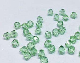 Chrysolite 6mm Bicone SWAROVSKI® Crystal Beads #5301 package of 50. Light Pastel Green color Genuine Austrian Crystal. Bulk. #5328.