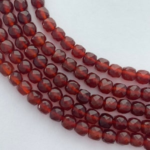 4mm faceted cube Carnelian gemstone beads. 15” strand of dark orange faceted cubes, approximately 85-86 per strand.