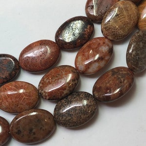 13x18mm Oval Red Fossilized Coral Beads. Full 15&quot; strand of A/AA grade beads, 20 beads per strand. Tan, grey, brown and yellow fossil coral.