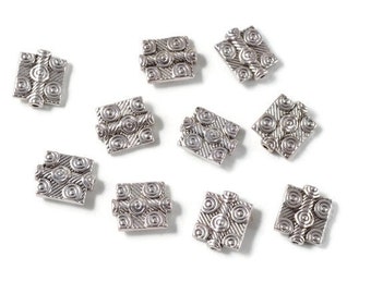Antique Silver Bali Style Rectangle Flag Beads. Package of 10 pieces. Carved swirl or bulls eye pattern, double sided. Flat rectangle bead.
