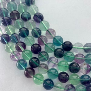 8mm Rainbow Fluorite gemstone beads.  15” strand of high quality (grade A) round beads, approximately 48 per strand.  Lot A