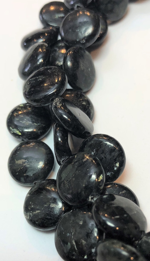 black gemstone with gold flecks