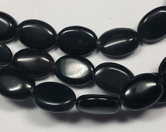 Black Obsidian Gemstone Beads. Full 15" strand of 10x14mm puffed oval beads, about 28 beads per strand. Black with some rainbow flash.