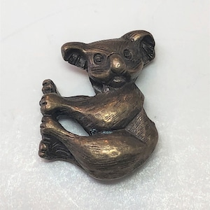 Antique Pewter or Brass Koala Bear Bead. 3 dimentional pewter bead with brass or pewter plating. 2mm hole size, center drilled. Pkg of 3.