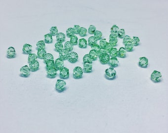 Chrysolite 4mm Bicone SWAROVSKI® Crystal Beads #5301 package of 50. Light Pastel Green color Genuine Austrian Crystal. Bulk. #5328.