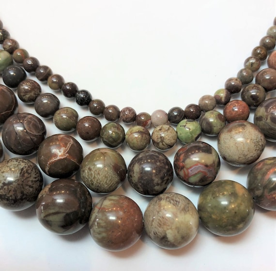 Dark Green Rain Forest Jasper Gemstone Beads. Full 15" strand of round AA/AAA grade beads. Dark green Rhyolite with orange.