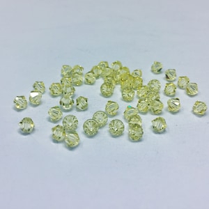Jonquil 4mm Bicone SWAROVSKI® Crystal Beads #5301 package of 50. Light Pastel Yellow color Genuine Austrian Crystal. Bulk. #5328.