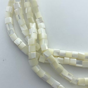 6mm cube white Mother of Pearl gemstone beads. 15” strand of shell cubes, approx. 72 beads per strand.