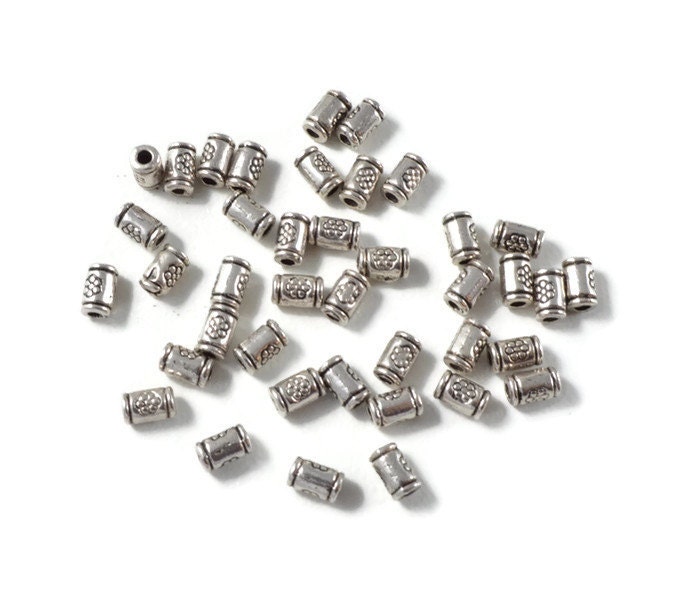 Antique Silver Bali Style Flower Stamped Tube Beads, package of 50 beads. 3mm by 5mm tube spacer bead. Flower stamped on two sides. Cylinder