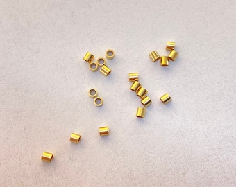 2x2mm gold-filled crimp beads. Used to crimp beading wire to clasp.  Sold in packs of 20.