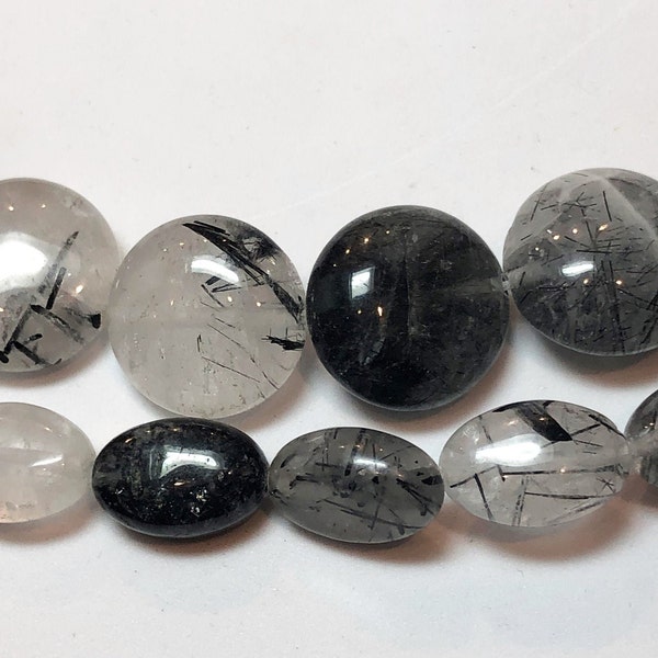 Black Tourmalated Quartz gemstone beads, available in 8x12mm rice and 14mm coin. 15" strands of clear Quartz rutilated with black Tourmaline