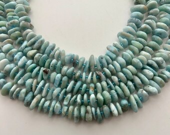 10-14mm irregular slices of Larimar gemstone chips. 16" strand pale blue and white Larimar beads, approx. 90 per strand.