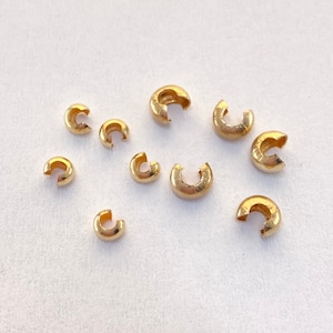 3mm and 4mm Gold-filled crimp covers. Used next to clasp to cover crimps. Looks likes bead when closed.