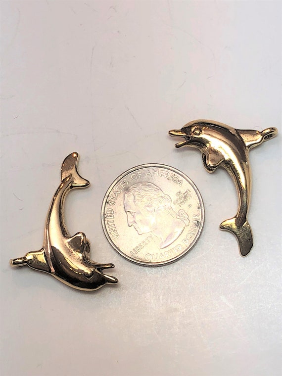 34mm long and 19mm wide Package of 2. Pewter Dolphin pendant with antique pewter or gold finish