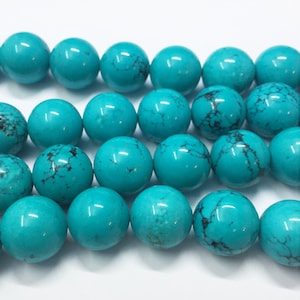 Turquoise Dyed Magnesite Gemstone Beads. 14mm round beads on 15 inch strand. Full strand of beads, about 29 per strand. Imitation Turquoise