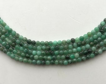 3mm round Emerald gemstone beads. 15” strand of mixed green Emerald beads, approx. 125 per strand.