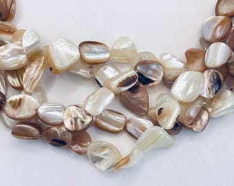 Mother of Pearl shell nugget gemstone beads. 15” strand of cream and Sienna pink nuggets, about 33-36 beads per strand.