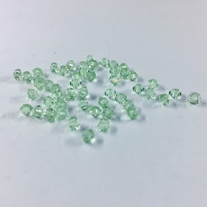 Chrysolite 3mm Bicone SWAROVSKI® Crystal Beads #5301 package of 50. Light Pastel Green color Genuine Austrian Crystal. Bulk. #5328.
