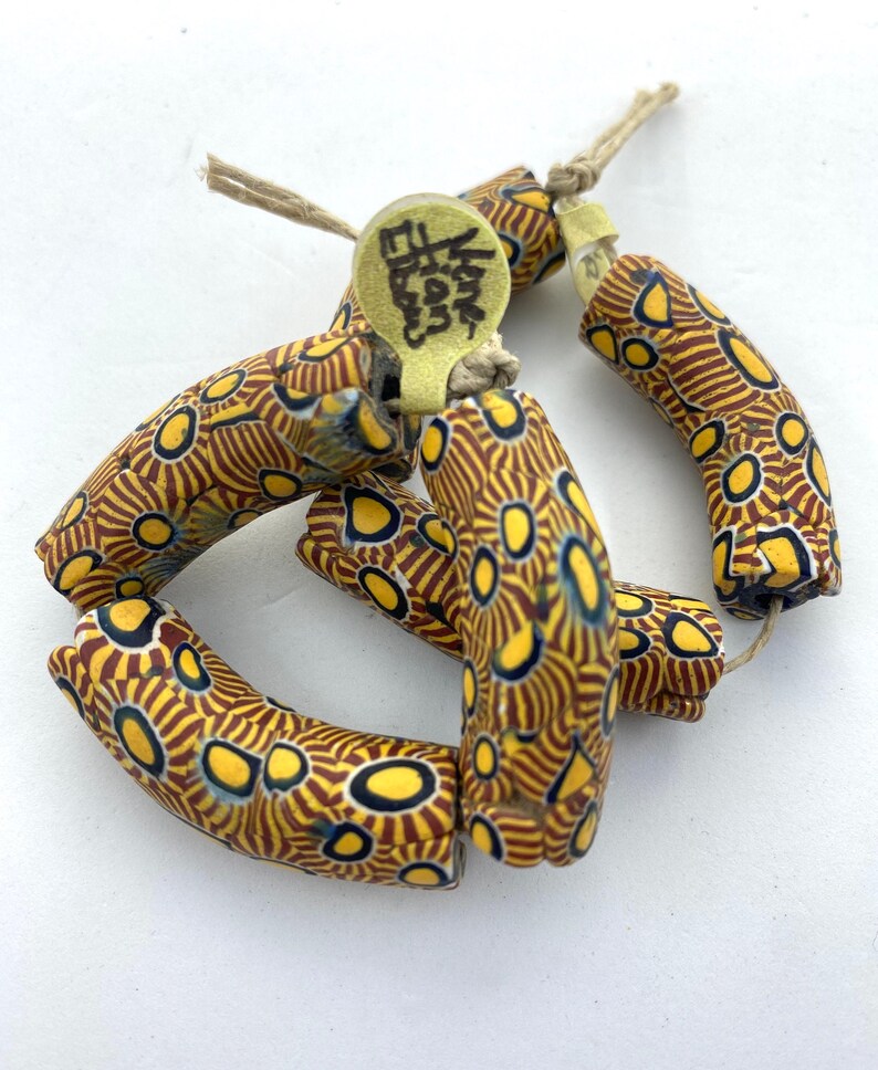 40mm in length and 12mm dia. Strand of 3 \u201celbow\u201d beads in excellent condition Approx Antique Venetian Millefiori African Trade Beads